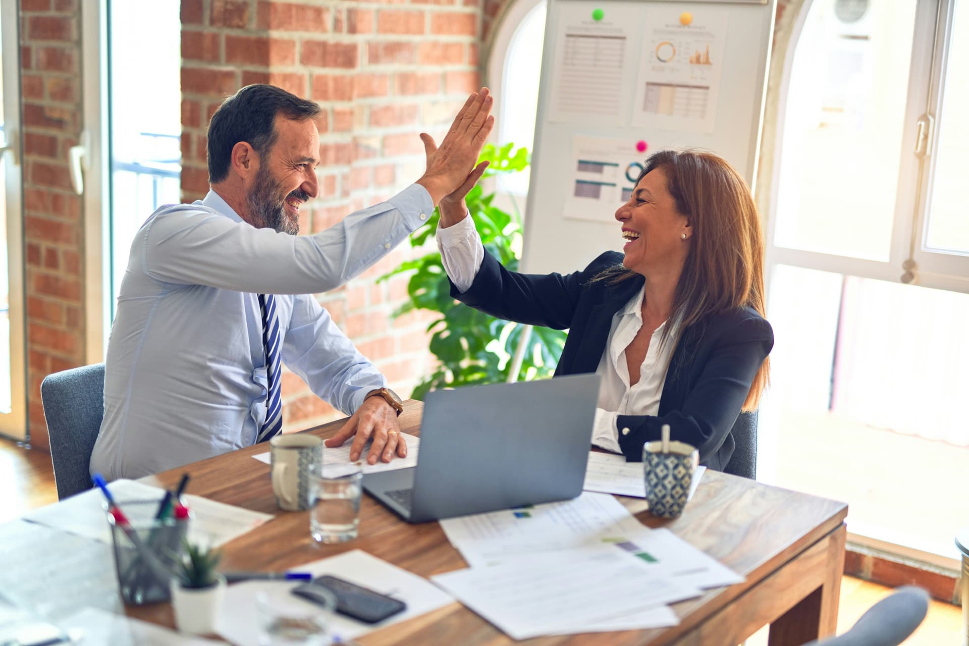 Two professionals celebrating with a high-five